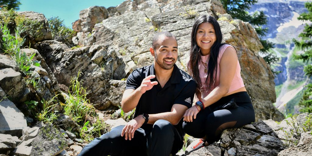 a man and a woman are sitting on rocks