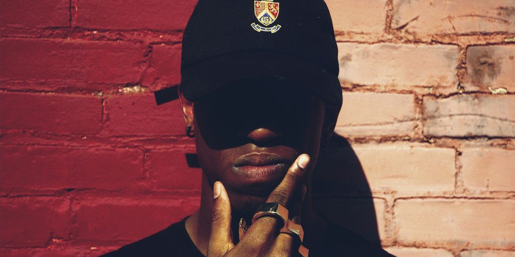 man with cap and background with red and pink wall l