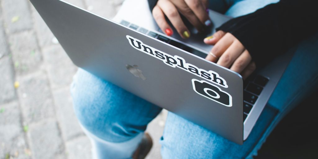 person holding gray laptop